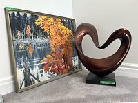 Overall view of framed painting and wood sculpture together