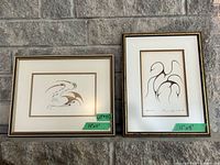 Both framed prints side by side showing size, orientation and overall frame condition