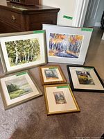 Group shot of all five framed artworks on floor
