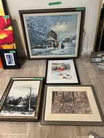 Group of four framed winter and rural artworks on floor