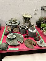 Group shot of entire lot on table showing bird bath, pagoda lantern, solar lanterns, signs, tray, figurines
