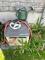 Storage box, hose, sprinkler head, watering can together