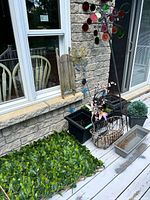 Overall lot showing planters, stakes, basket, topiary, foliage mat