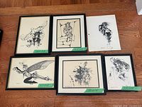 Six of the seven prints laid out on floor, showing framing and one unframed sheet