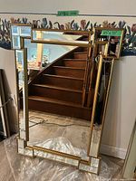Front view of gold geometric beveled glass wall mirror