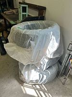Stack of four wrapped tires