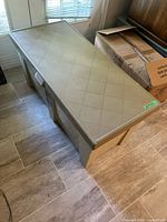 Angled top and side view of beige plastic deck box