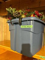 closed tote with garland showing pinecones, berries, gold ornaments