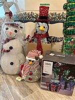 Group shot showing large snowman, penguin, small snowman and sealed Canvas gift box set