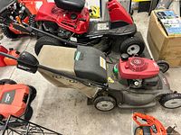 Overall left side view showing mower, grass bag, handle and engine