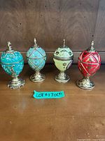 Front view of four Fabergé style musical egg boxes on stands