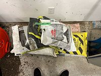 Stack of mixed ice melt bags showing quantity and brands