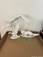 Overall view of both porcelain figurines on tray