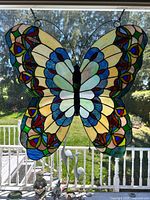 Front view of entire butterfly suncatcher hanging in window