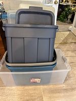 Stacked blue and gray totes inside clear tote