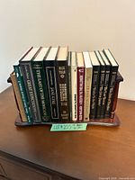 Front view of all books on wooden rack