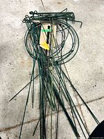 Pile of green stakes and several rings