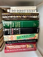 Stack of vintage cookbooks showing spines and formats