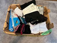 Box containing assorted packaged socks and tights