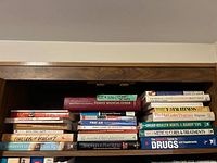 Overview of shelf showing multiple health and self-help books stacked horizontally