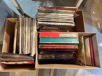 Two cardboard boxes filled with vertically stored vinyl LPs