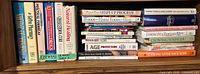Full shelf showing vertical medical reference titles and horizontal beauty/aging stack