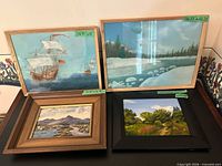 Group shot of all four framed paintings on table
