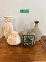All four ceramic items grouped on table