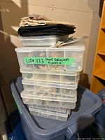 stack of clear plastic storage boxes with brush roll on top