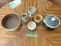 Group shot of all seven stoneware and ceramic pieces on table