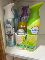 Front view showing Febreze citrus aerosol, Air Wick refill and additional cans