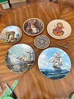 All six plates, small mosaic plate, and two display supports on table