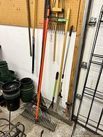 Overall view of rakes leaning and hanging showing various types and materials