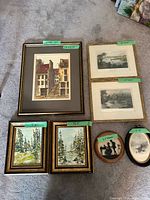 Group shot of all seven framed artworks laid on floor