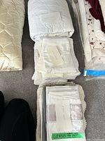 Stacked lot showing pillowcases, protectors and mattress covers
