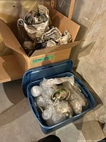 Tote with glass shades, bulbs, canopy; box with wrapped fixtures