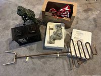 All items grouped: pair lanterns, ceramic girl statue, sprinkler, statue parts in Styrofoam, box of Canada Day decor