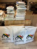 Stacks of shrink-wrapped canvases and shopping bags