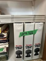 Stack of McCall's Cookery booklets and binders on shelf