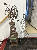 Obelisk with armillary sphere beside spiral cage