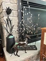 Greyhound sculpture beside vase and leaf panel showing scale and finishes
