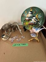 Full lot showing plate, stand, metal geese, glass birds, porcelain bird on nest, resin chickadee