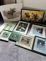 Group shot showing all nine artworks arranged on floor