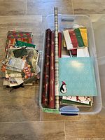 Overview of wrapping rolls, stacked gift bags, tissue paper and tags