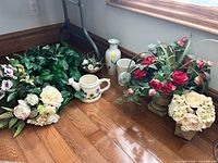 Group shot of all silk floral items and ceramic planters on floor