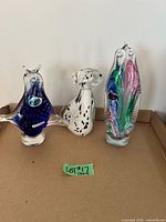 Group shot of all three Murano glass figurines on tray