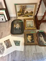 Framed oil landscape with other artworks around it for scale