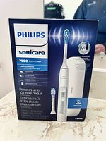 Front of retail box showing Philips Sonicare 7500 ExpertClean toothbrush and travel case