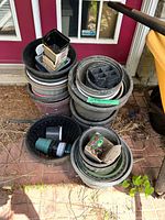 Stacks of assorted plastic pots in multiple sizes and colors