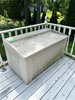 Oblique front view of deck box showing color, size, mildew on lower panel